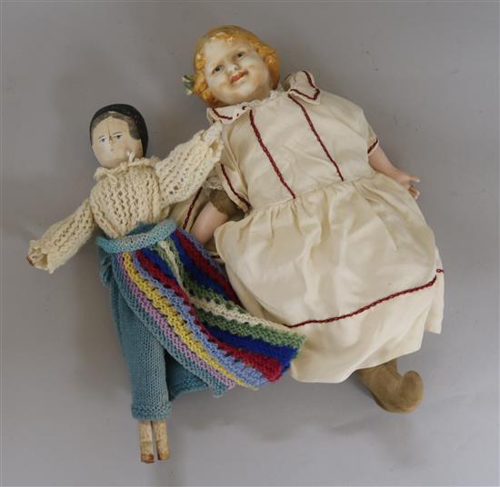 A bisque headed doll and a peg dolls and clothing